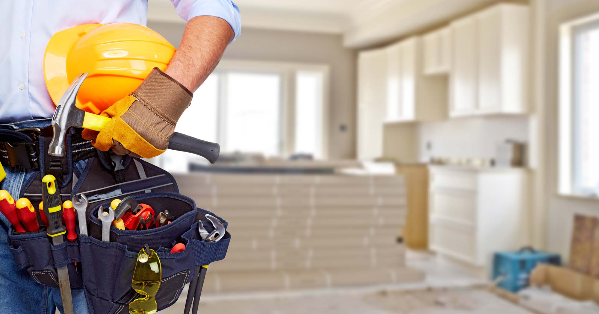 Builder handyman with construction tools. House renovation background.