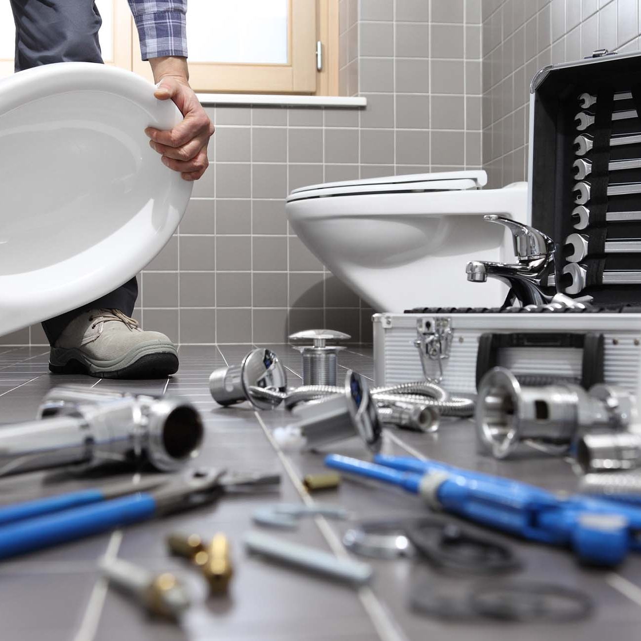 Plumber at work in a bathroom, plumbing repair service, assemble and install concept
