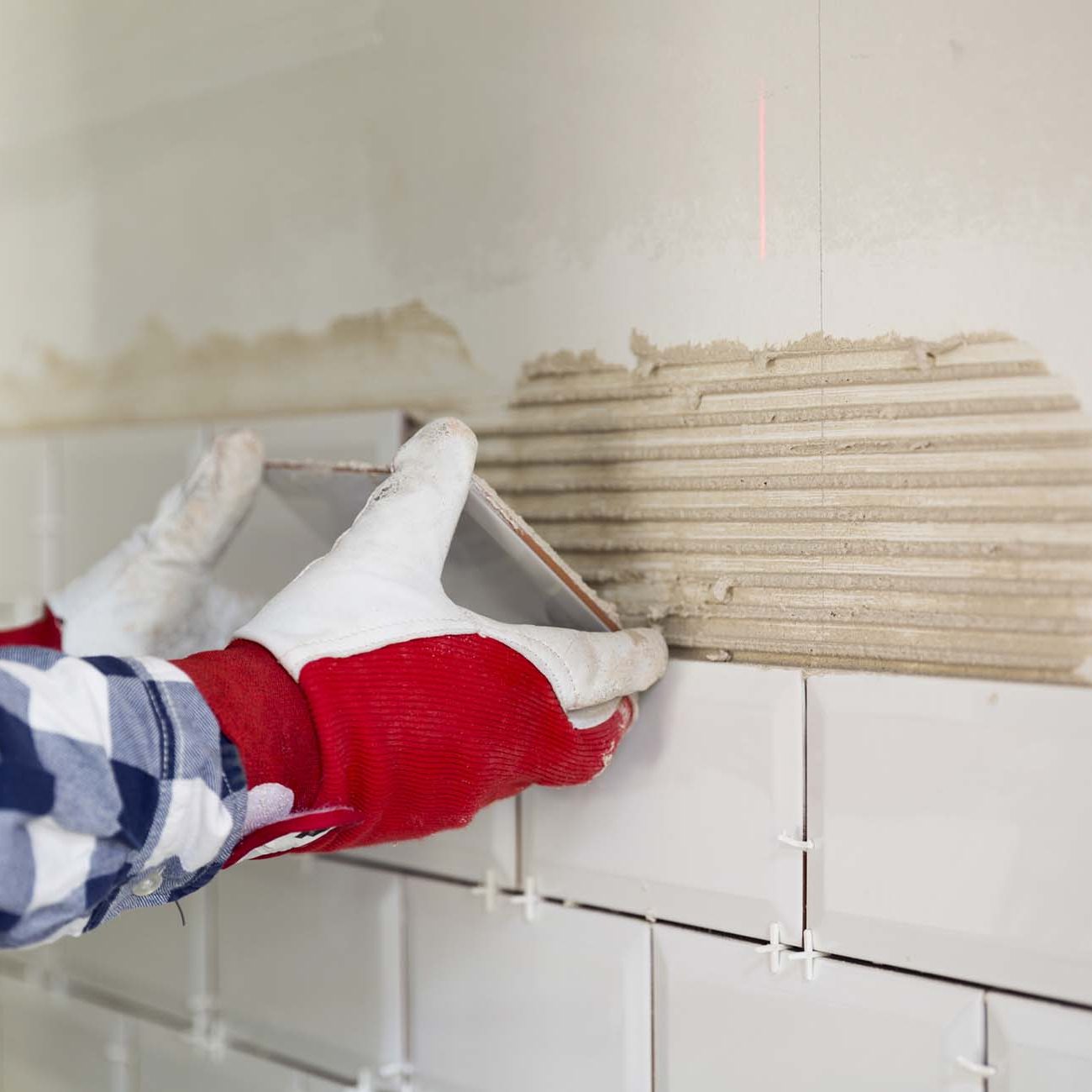 Process of tiling the tiles in the kitchen. Home improvement, renovation concept